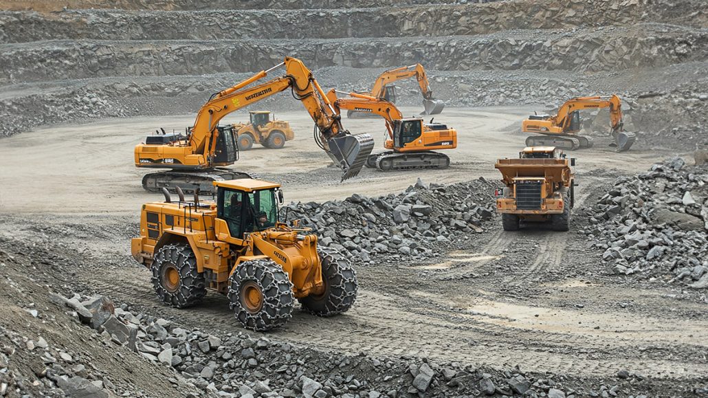 Heavy-duty machinery operating in a mining site with Tire Protection Chains, preventing tire wear and ensuring traction on rocky terrain.