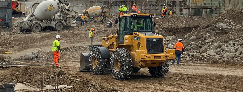 A large mining truck equipped with Tire Protection Chains, preventing tire damage and ensuring stability on rocky and abrasive terrain.